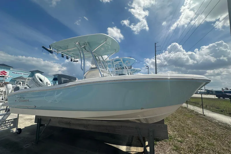 The Image of 2026 Pioneer 202 Sportfish boat displayed outdoors under a partly cloudy sky. - 1