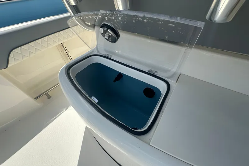 Slide: The Image of Livewell compartment on a 2026 Pioneer 202 Sportfish boat, open lid view. - 11