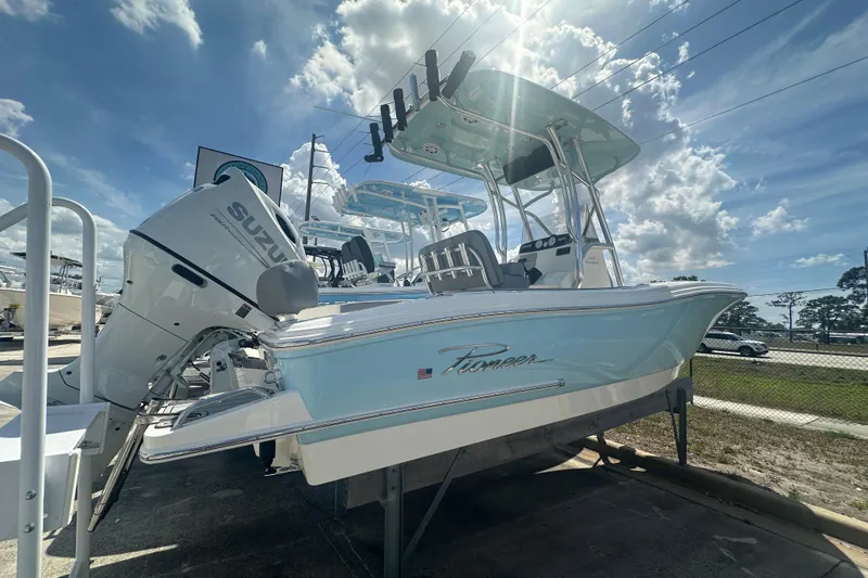 Slide: The Image of 2026 Pioneer 202 Sportfish boat with Suzuki engine under a bright blue sky. - 3
