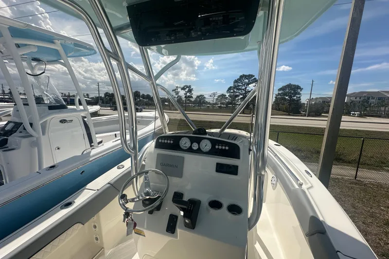 Slide: The Image of 2026 Pioneer 202 Sportfish boat interior with steering wheel and Garmin navigation system. - 5