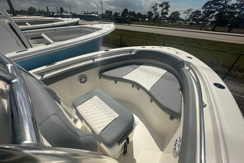 Slide: The Image of 2026 Pioneer 202 Sportfish boat interior with cushioned seating and sleek design. - 6