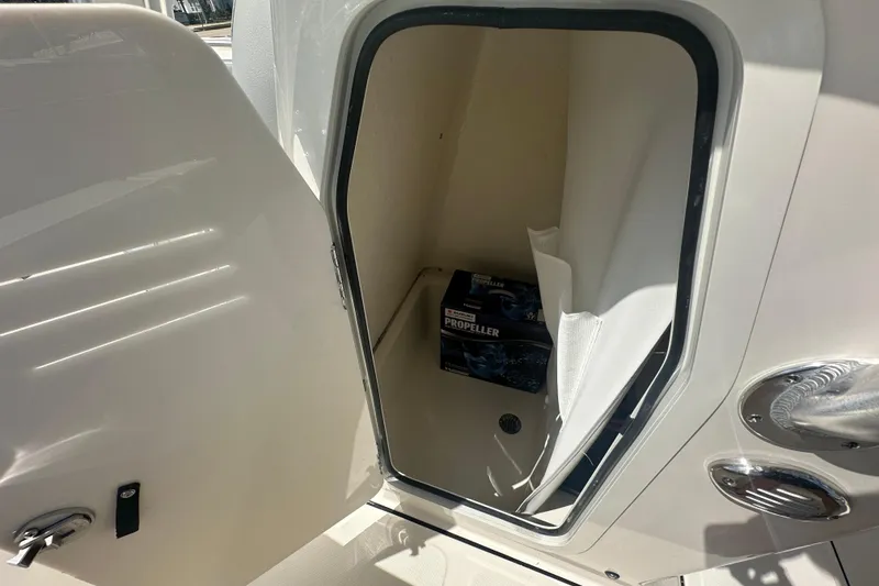 Slide: The Image of Open storage compartment on 2026 Pioneer 202 Sportfish boat with propeller box inside. - 8