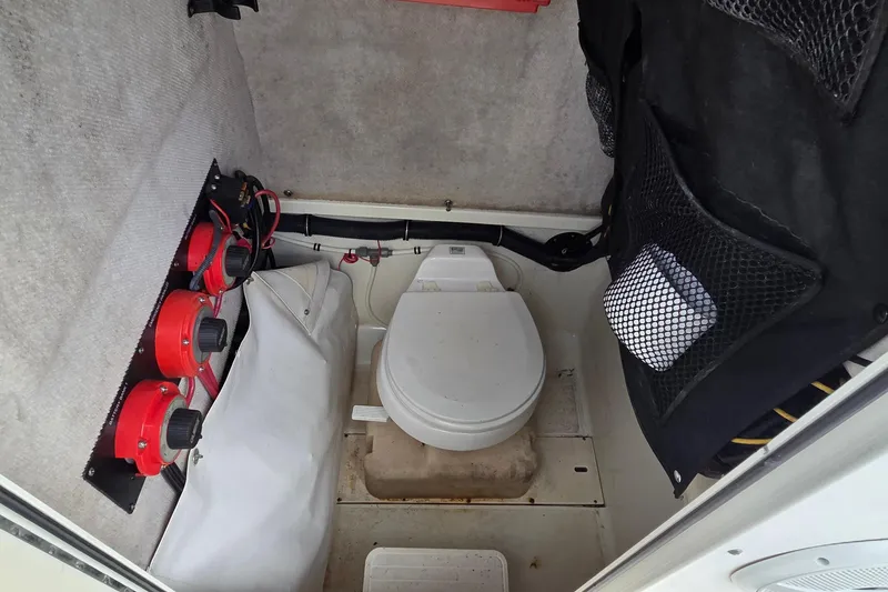 Slide: The Image of 2004 Hydra-Sports Vector 2400 CC boat interior with toilet and storage compartments. - 11