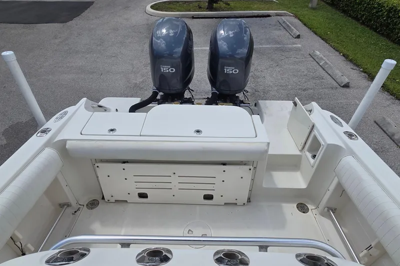 Slide: The Image of 2004 Hydra-Sports Vector 2400 CC boat with twin Yamaha 150 engines, parked on pavement. - 13