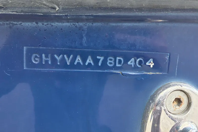 Slide: The Image of 2004 Hydra-Sports Vector 2400 CC hull identification number on blue surface. - 16
