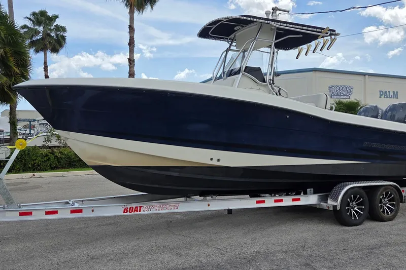 Slide: The Image of 2004 Hydra-Sports Vector 2400 CC boat on trailer, parked near palm trees. - 9