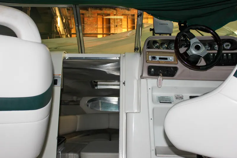 Slide: The Image of Interior view of 2000 Chaparral 245 SSi boat, featuring cockpit and cabin entrance. - 12