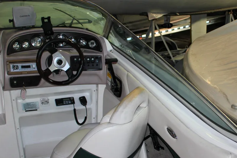 Slide: The Image of Interior view of a 2000 Chaparral 245 SSi boat cockpit with steering wheel and controls. - 13