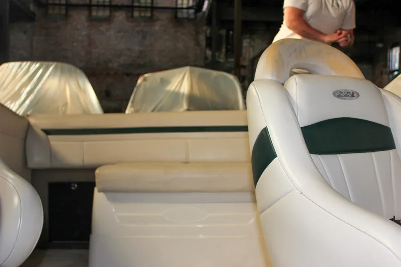 Slide: The Image of Interior of a 2000 Chaparral 245 SSi boat with white and green seating. - 14