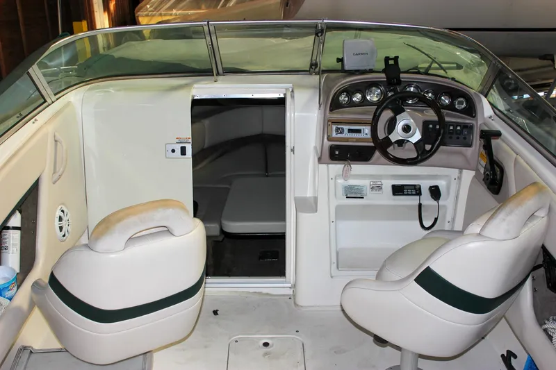 Slide: The Image of 2000 Chaparral 245 SSi boat interior with steering wheel and seating area. - 2