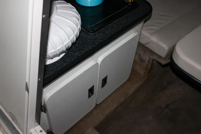 Slide: The Image of Interior of 2000 Chaparral 245 SSi boat with storage cabinets and seating area. - 6