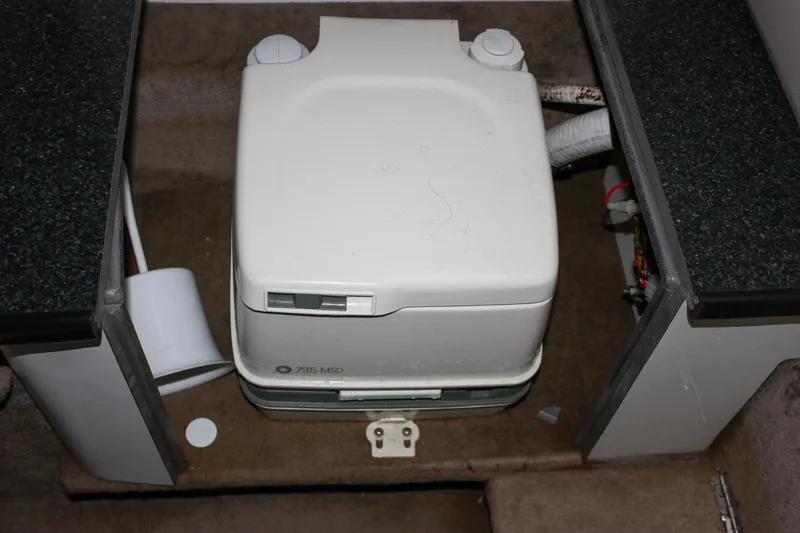Slide: The Image of Portable toilet in a 2000 Chaparral 245 SSi boat interior. - 7