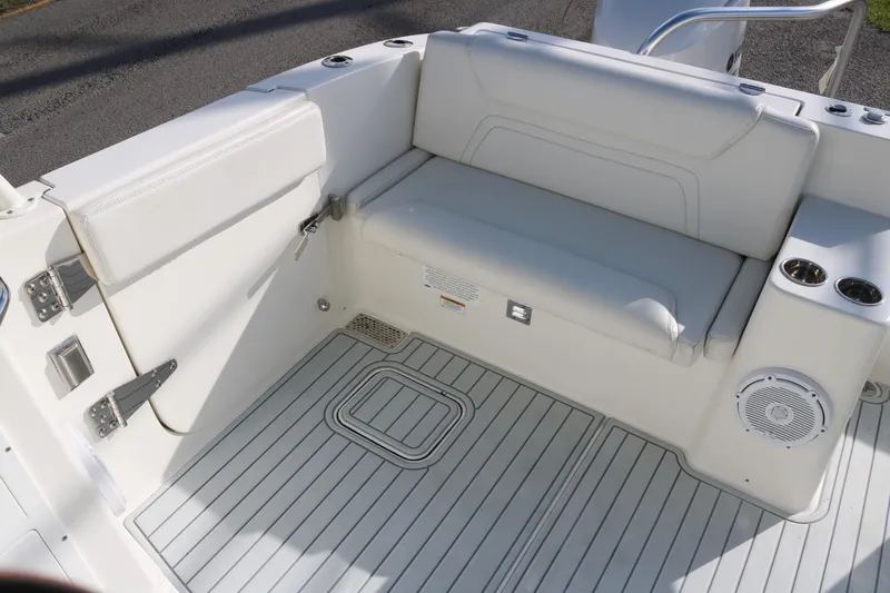Slide: The Image of 2019 World Cat 320 DC boat interior with cushioned seating and cup holders. - 14