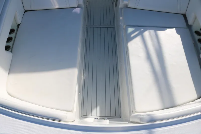 Slide: The Image of 2019 World Cat 320 DC boat interior with white cushioned seating and sleek design. - 7