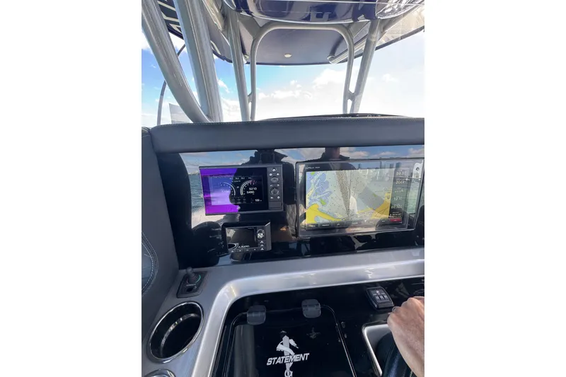 Slide: The Image of 2019 Statement 380 Open boat with triple Mercury engines on open water. - 7