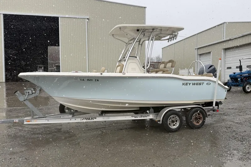 The Image of 2019 Key West 219 FS boat on trailer in snowy outdoor setting. - 0