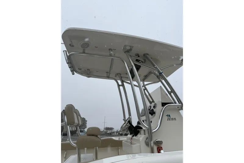 Slide: The Image of 2019 Key West 219 FS boat with T-top and seating, overcast sky background. - 7