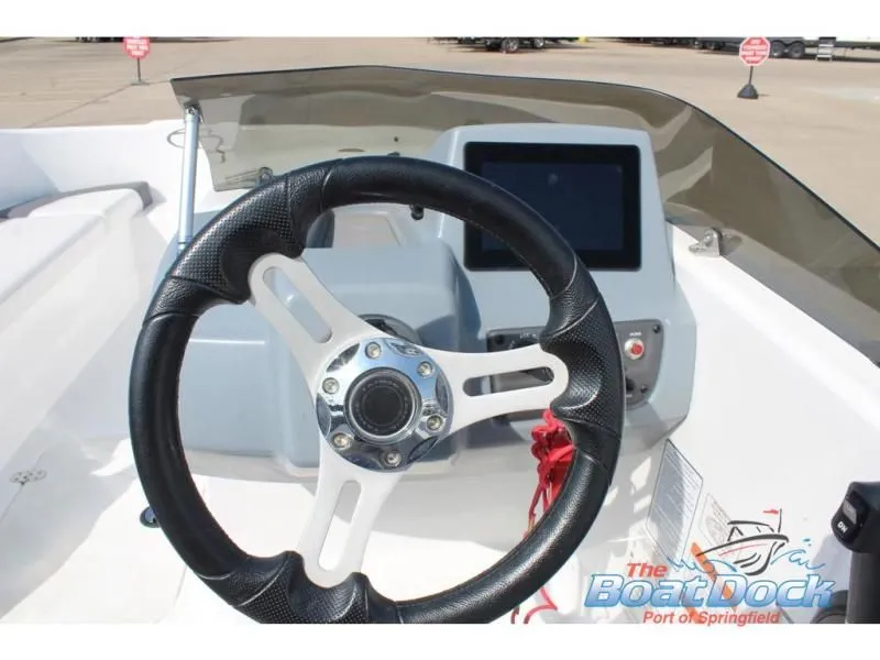 Slide: The Image of Steering wheel and dashboard of a 2023 Tahoe T16 boat. - 11