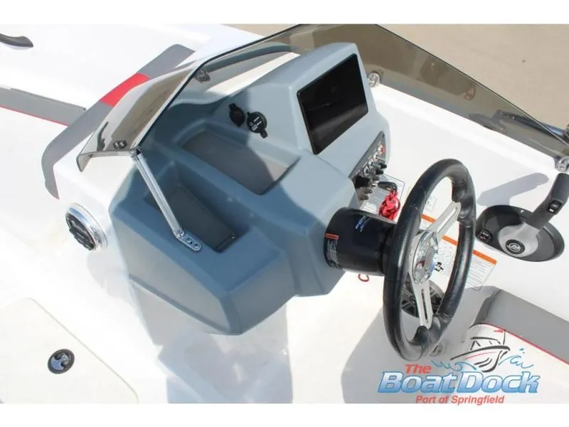 Slide: The Image of 2023 Tahoe T16 boat dashboard with steering wheel and controls. - 18