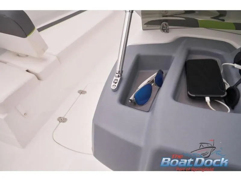 Slide: The Image of Interior of 2023 Tahoe T16 with sunglasses and smartphone. - 49