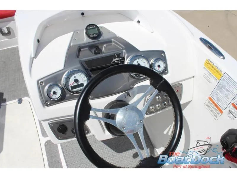 Slide: The Image of Dashboard of a 2022 Tahoe 2150 boat with steering wheel and gauges. - 10