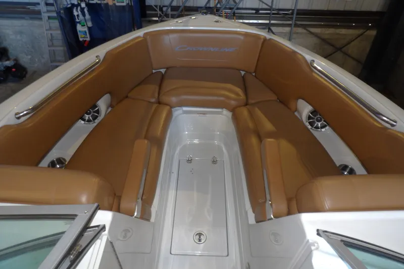 Slide: The Image of 2023 Crownline 250 XSS boat interior with tan seating and stainless steel accents. - 11