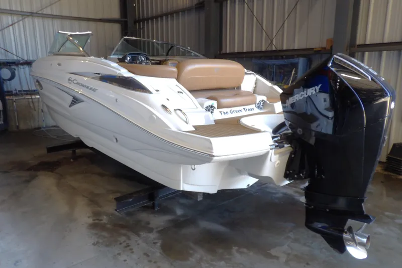 Slide: The Image of 2023 Crownline 250 XSS boat with Mercury engine in a storage facility. - 14
