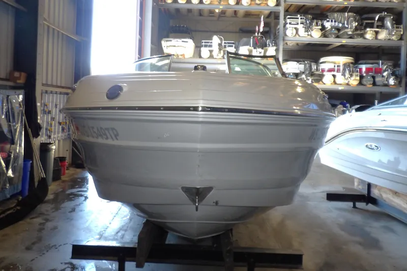 Slide: The Image of 2023 Crownline 250 XSS boat in storage, front view, showcasing sleek design. - 15