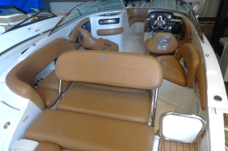 Slide: The Image of 2023 Crownline 250 XSS boat interior with tan leather seating and modern dashboard. - 4