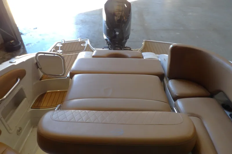 Slide: The Image of 2023 Crownline 250 XSS boat interior with tan seating and swim platform. - 6