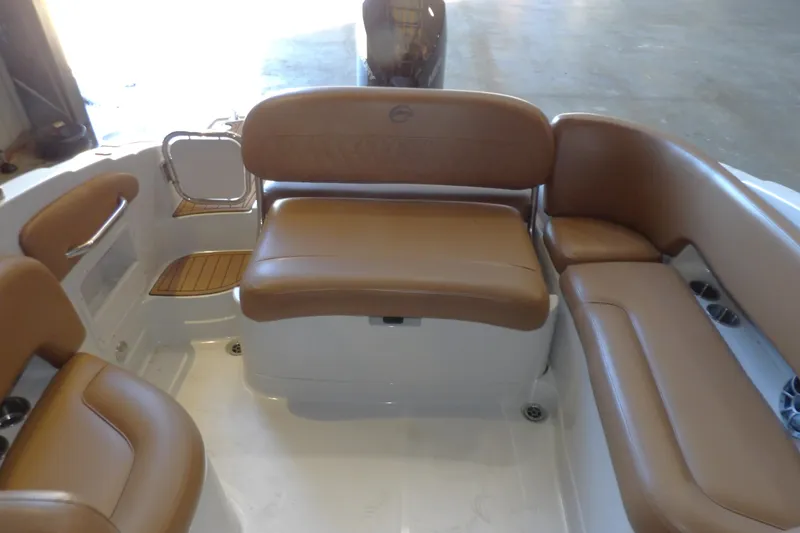 Slide: The Image of 2023 Crownline 250 XSS boat interior with tan leather seating and white deck. - 7