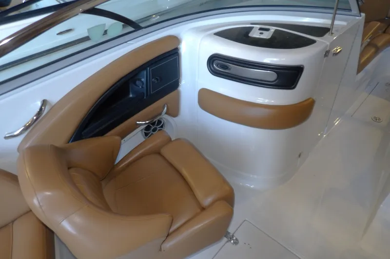 Slide: The Image of 2023 Crownline 250 XSS boat interior with tan seating and sleek design. - 8