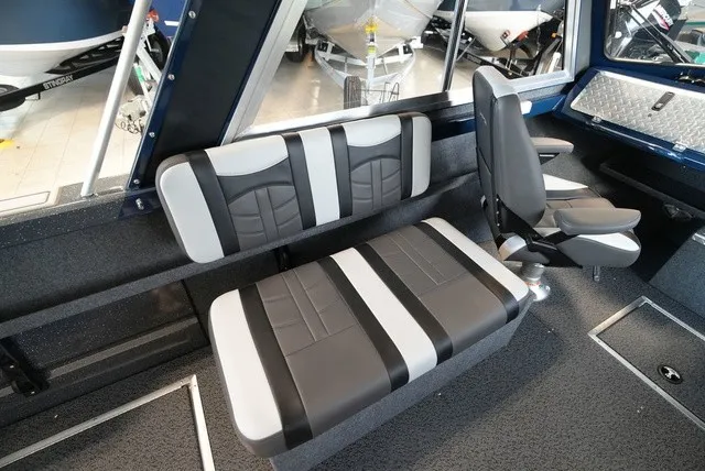 Slide: The Image of Interior of a Lund 185 Heavy Gauge Sport boat with cushioned seating and modern design. - 25