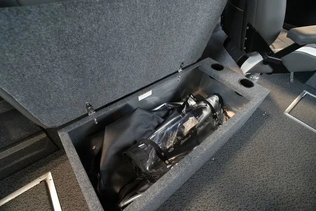 Slide: The Image of An open storage compartment in the boat with gear and accessories. - 26