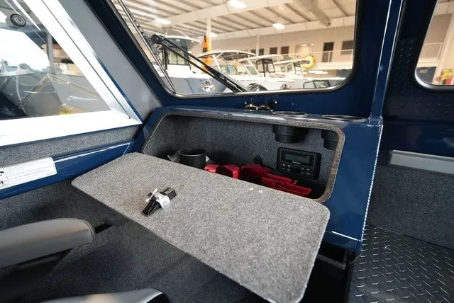 Slide: The Image of Interior view of a 2027 Lund 185 Heavy Gauge Sport with storage and cup holders. - 33