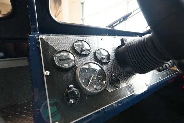 Slide: The Image of Dashboard of a Lund 185 Heavy Gauge Sport with multiple gauges and a steering wheel. - 31