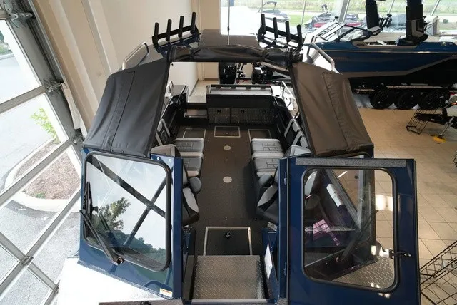 Slide: The Image of The image shows a 2027 Lund 185 Heavy Gauge Sport boat with a spacious interior and multiple seats. - 40