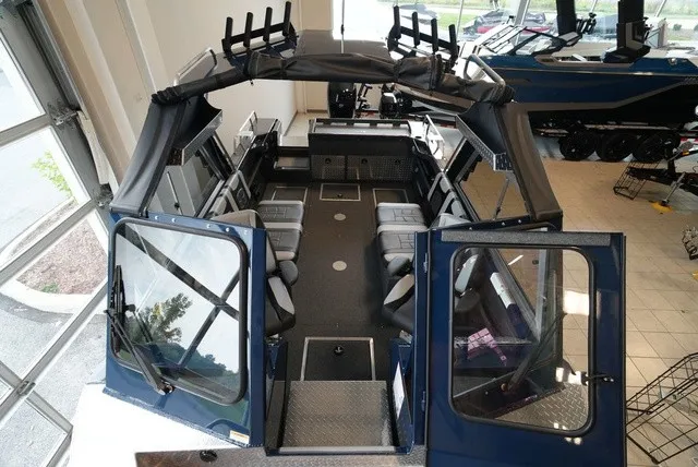 Slide: The Image of Interior view of a Lund 185 Heavy Gauge Sport boat with gray seating and black canopy. - 41