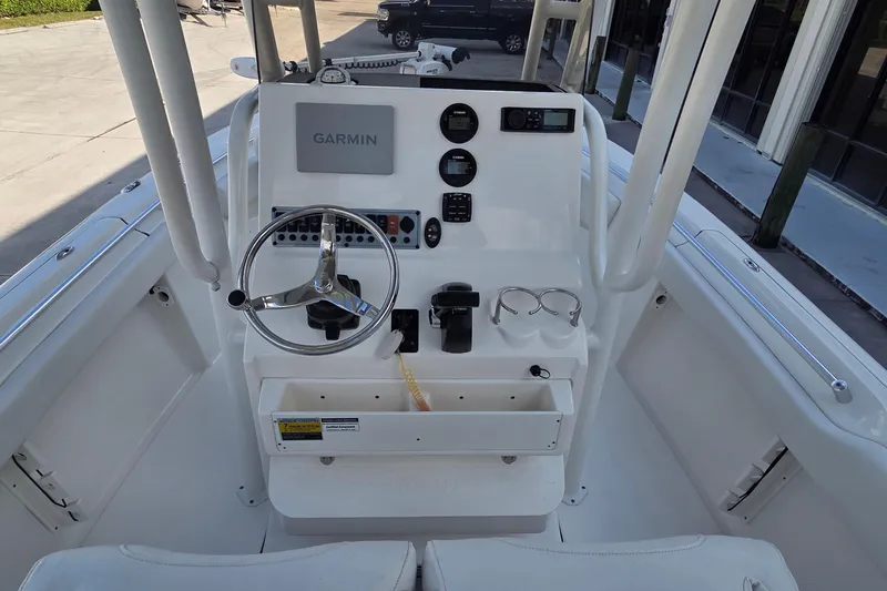 Slide: The Image of 2023 Key West 219 FS boat console with Garmin navigation system and steering wheel. - 26