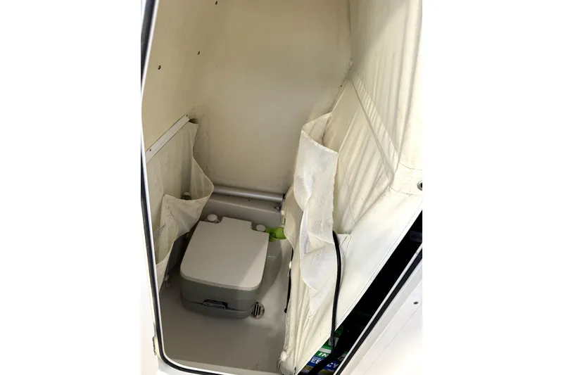 Slide: The Image of 2023 Key West 219 FS boat interior with compact marine toilet. - 5