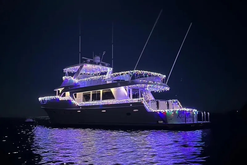 Slide: The Image of Ocean Alexander 700 Classicco 2003 yacht illuminated with festive lights at night on water. - 16