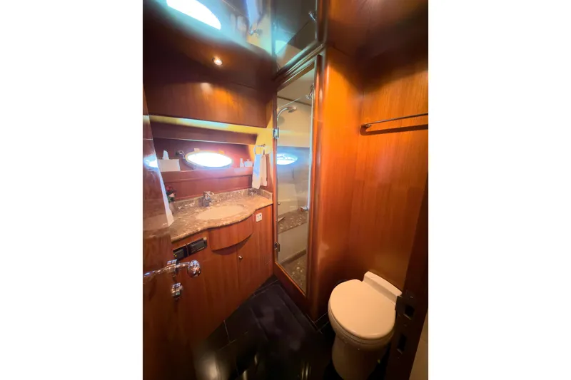 Slide: The Image of Luxurious 2003 Ocean Alexander 700 Classicco yacht bathroom with wood accents and modern fixtures. - 34