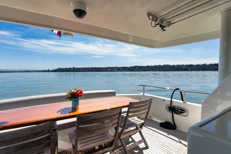 Slide: The Image of Outdoor dining area on 2003 Ocean Alexander 700 Classicco yacht with scenic water view. - 39