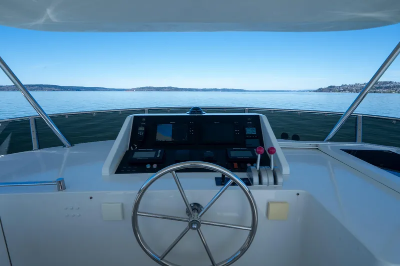 Slide: The Image of Helm of 2003 Ocean Alexander 700 Classicco yacht with serene ocean view. - 40