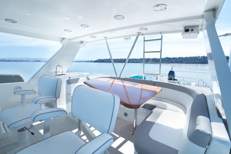 Slide: The Image of Luxurious 2003 Ocean Alexander 700 Classicco yacht interior with elegant seating and scenic ocean view. - 42