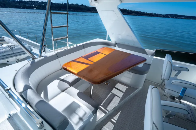 Slide: The Image of Luxurious seating area on 2003 Ocean Alexander 700 Classicco yacht, overlooking serene waters. - 43