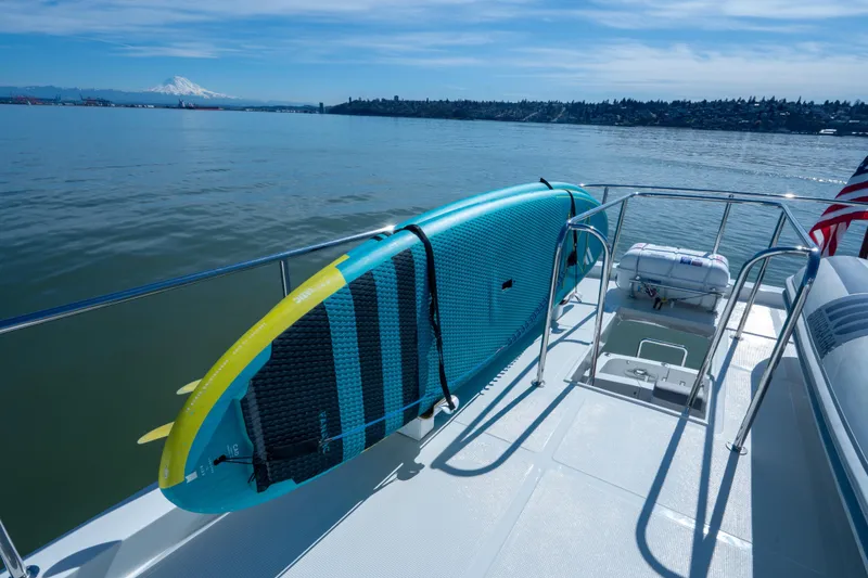 Slide: The Image of Ocean Alexander 700 Classicco yacht deck with paddleboard, 2003 model, scenic water view. - 46