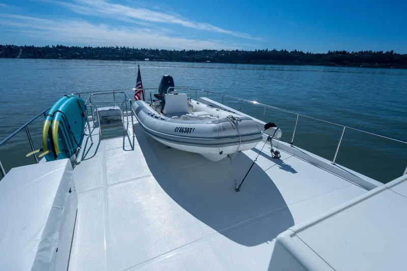 Slide: The Image of Deck of 2003 Ocean Alexander 700 Classicco yacht with inflatable boat and paddleboards. - 47