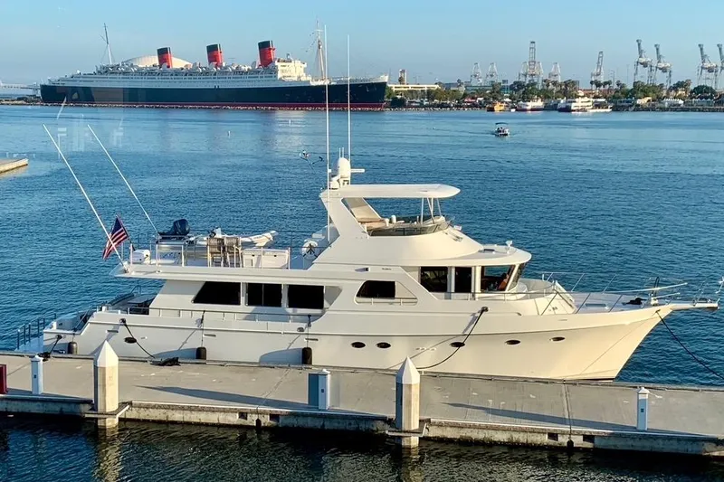 Slide: The Image of Ocean Alexander 700 Classicco yacht, 2003 model, docked in a serene marina setting. - 5
