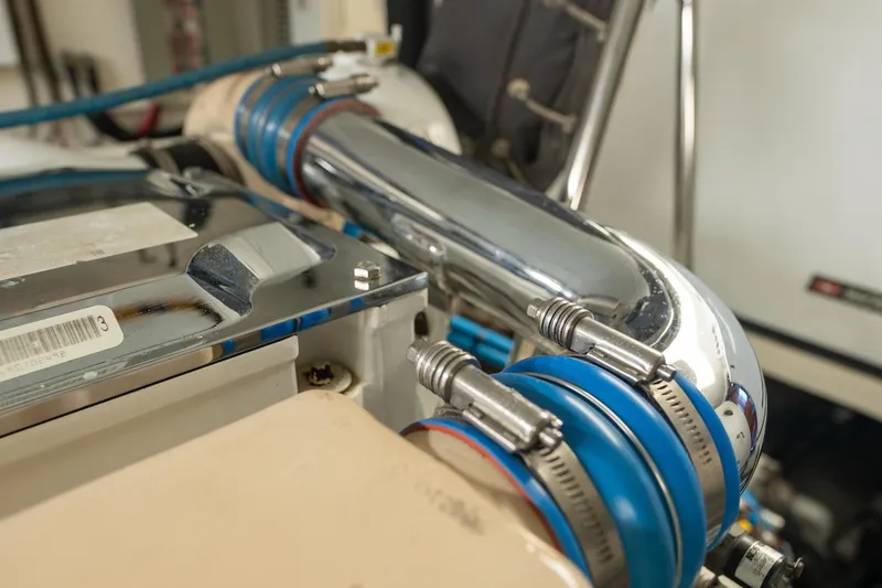 Slide: The Image of Engine compartment of a 2003 Ocean Alexander 700 Classicco yacht, featuring chrome and blue components. - 53